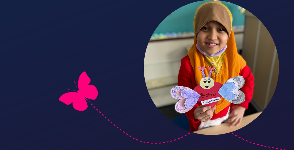 A Utica Academy of Science first grade Atom proudly displays their personalized Valentine’s Day card.