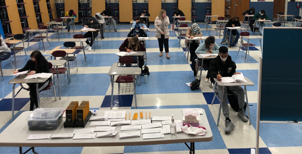 Utica Academy of Science high school students remain socially distant and sit 6 feet apart while taking the PSAT Exam.