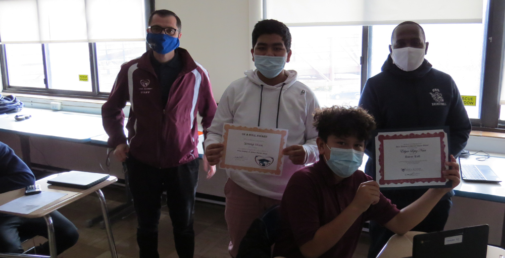 Utica Academy of Science middle school hybrid students receive honor roll certificates for their academic achievements during the first marking period.